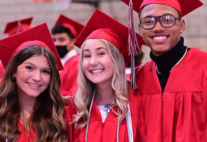 students in caps and gowns at graduation