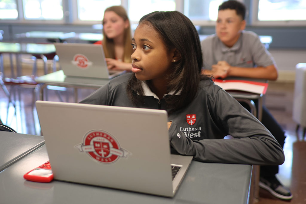 Lutheran West student in class on laptop