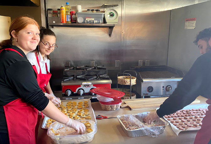 lutheran west students cooking in a commercial kitchen